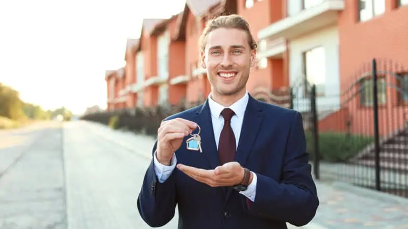 Un marchand de bien qui tient la clé de la future maison d'un client